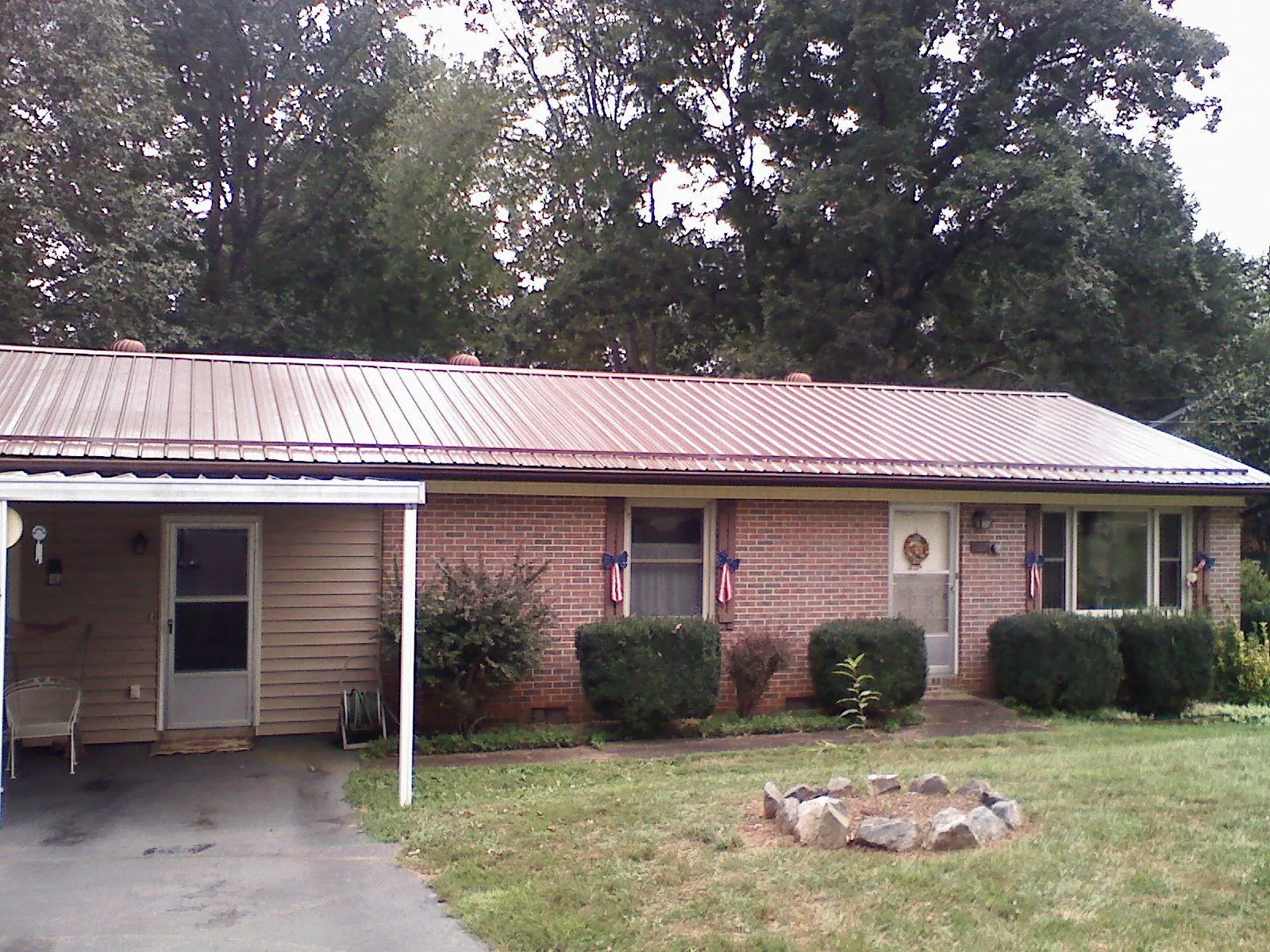Bronze metal roof and carport on a brick ranch home — Roof Repair work by our crew in Steeles Tavern